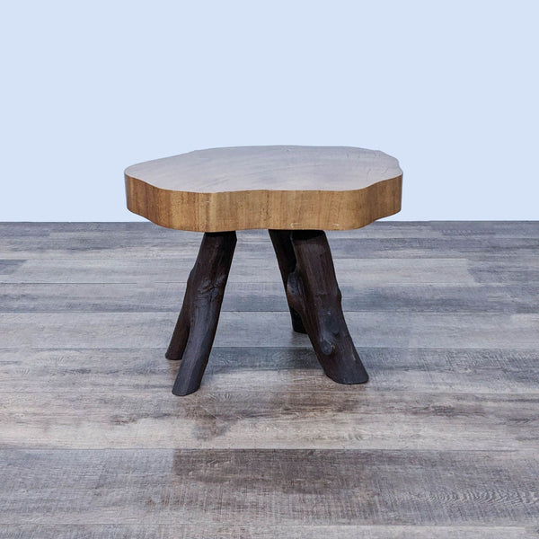 1. Reperch side table with natural finish wooden top and three dark, branch-like legs on a wood-patterned floor.