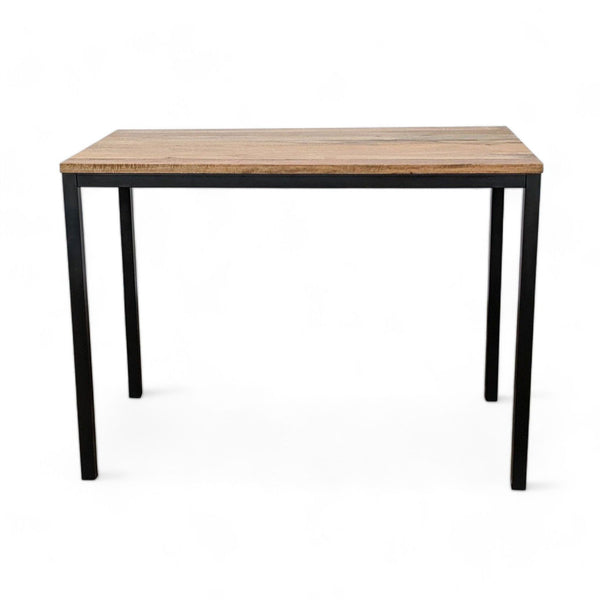 1. West Elm's Box Frame dining table with a solid mango wood top and sleek metal base against a white background.