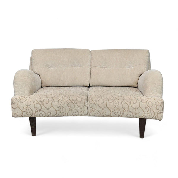 Neutral beige Reperch loveseat with decorative scroll pattern and wood finish feet, front view.