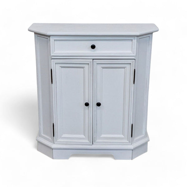 1. Ballard Designs Piccola end table with closed doors and a single drawer, showcasing paneled design and metal pulls on a white background.