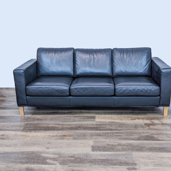 Reperch brand 3-seat black leather sofa with wooden legs front view.