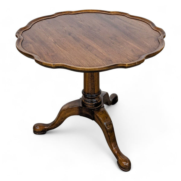 Reperch brand traditional wooden pedestal base end table with scalloped edges on a white background.