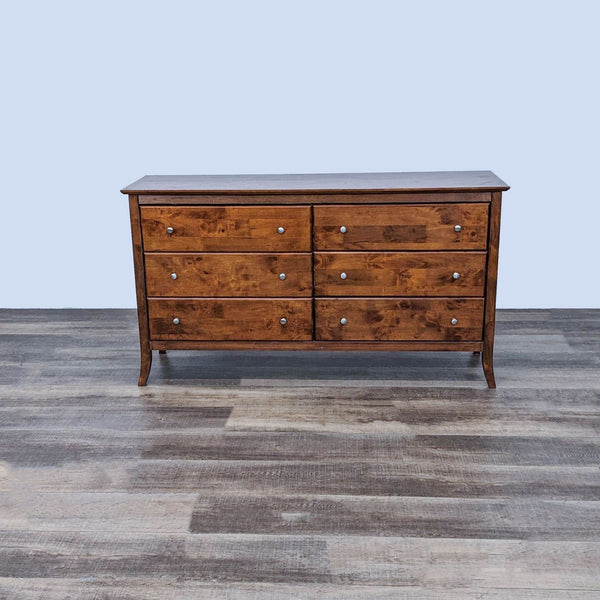 Timeless wooden dresser with six drawers and curved legs by Signivest Resources, frontal view on a wooden floor. 