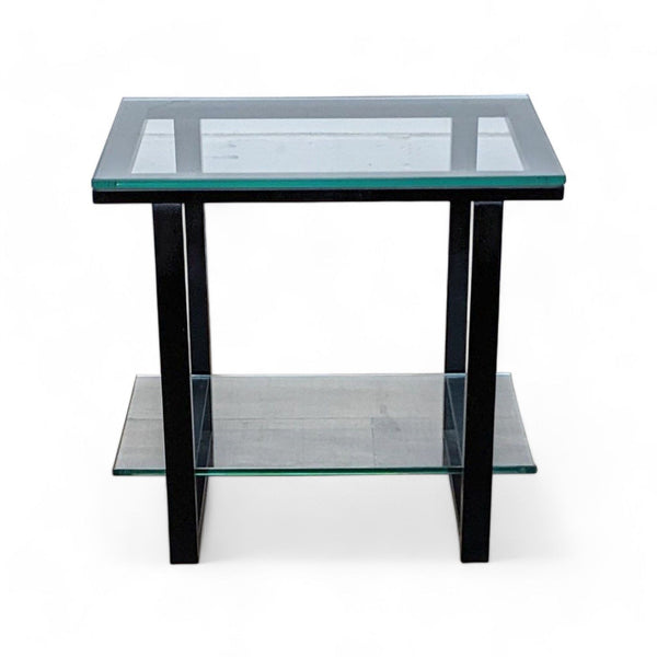 Crate & Barrel end table with glass top and lower shelf, metal frame, isolated on white.