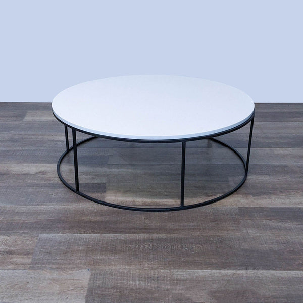 Room & Board coffee table with white quartz top and natural steel base on a wooden floor.