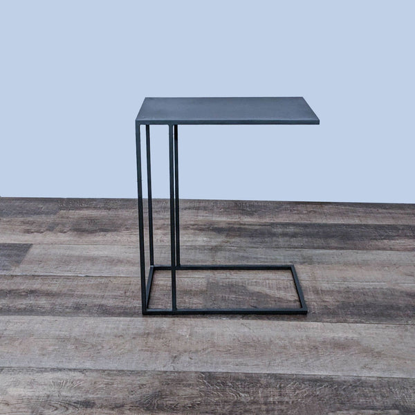 West Elm side table with a slate top and a slim black metal base on a wooden floor.