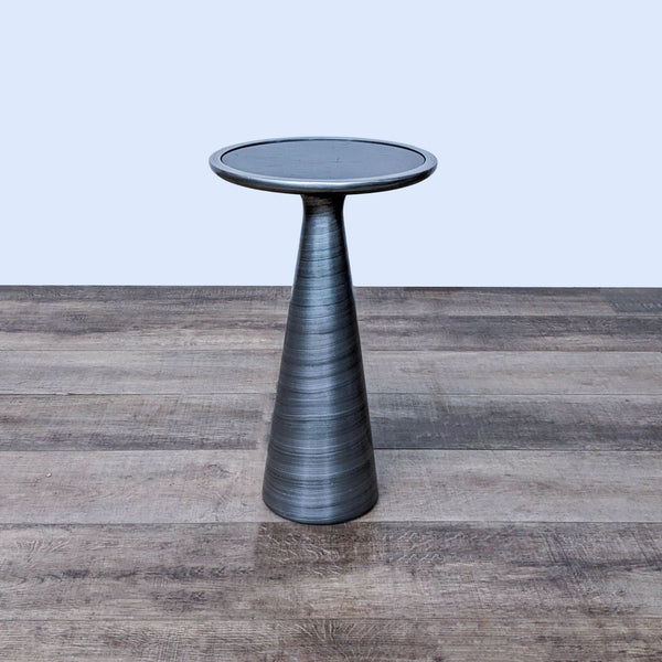 Brushed metal side table with a sleek black mirrored top on a wooden floor. Brand: Mitchell Gold + Bob Williams.