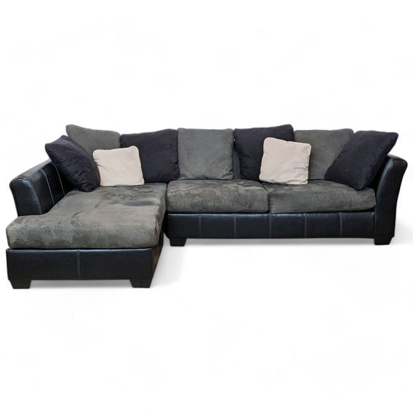 Ashley Furniture Jacurso 2-piece sectional with chaise, black pleather base, and grey microfiber cushions.