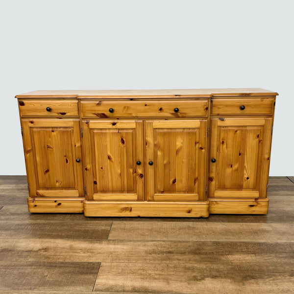1. Front view of a Ducal Furniture 4 door, 3 drawer pine sideboard, showcasing its classic design on a wooden floor.