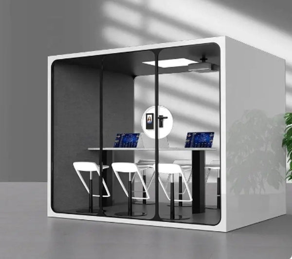 1. Disassembled Poppin office pod with glass walls, a desk, and chairs visible inside, assembly guide included.