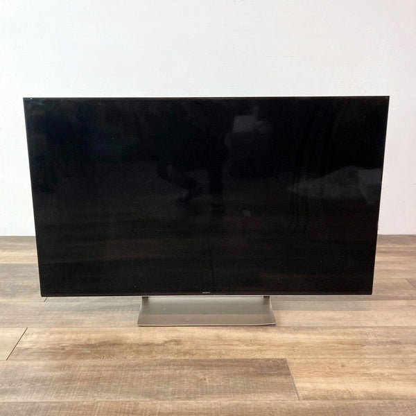 Sony TV displayed on wood flooring without remote or power cord, showing the screen side.