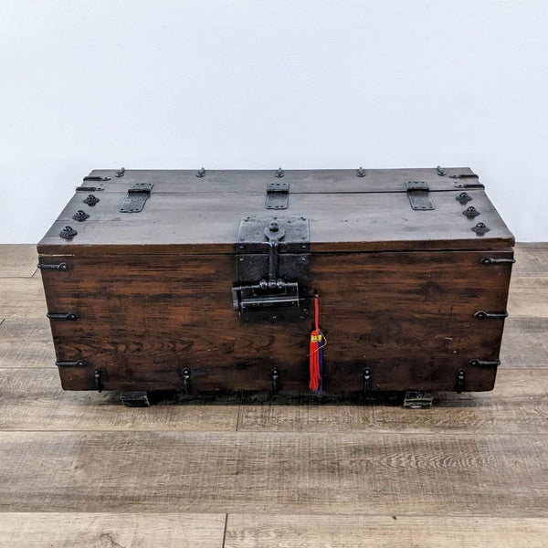 1. Closed 18th-century Reperch Korean coin chest, iron-bound with loop handles and red tassel on latch.