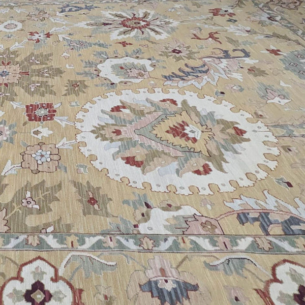 12'x18' Nourison Nourmak S174 Gold wool rug with intricate floral patterns in soft hues on a golden background.