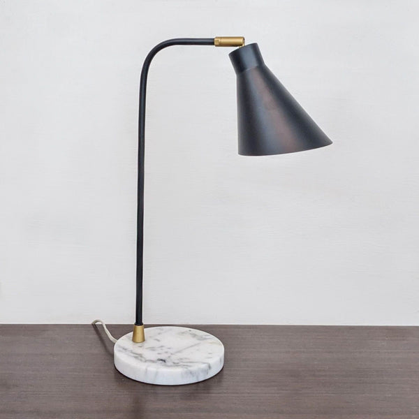 Reperch brand elegant black desk lamp with curved neck and marble base, turned off.