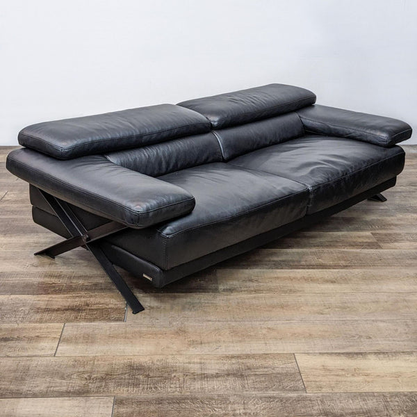 Roche Bobois black leather loveseat with adjustable headrests and cross metal side frame.