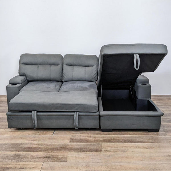Latitude Run gray sectional with storage chaise, pull-out ottoman, and cup holders in a staged setting.