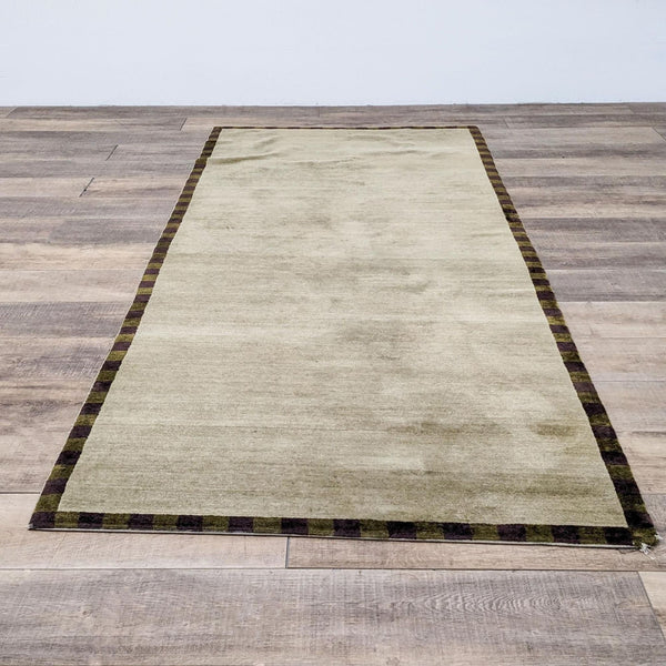 Reperch contemporary handwoven rug with medium pile, measuring 4'x9'9" on wooden floor.