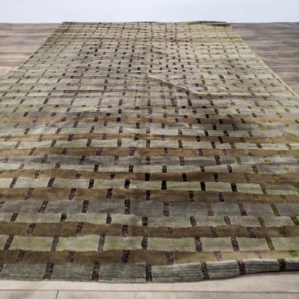 1. Tufenkian Tibetan 10'x14' area rug with a grid pattern of green and purple on natural wool, laid out on a hardwood floor.