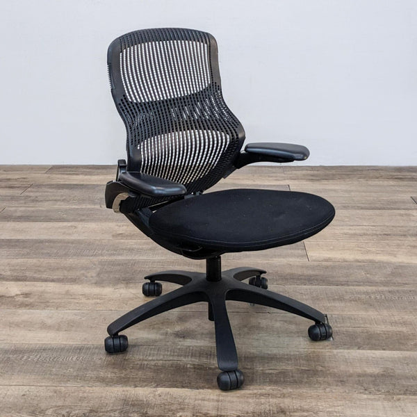 Knoll Generation office chair with black flex back net and distinct figure-8 support on wooden floor.