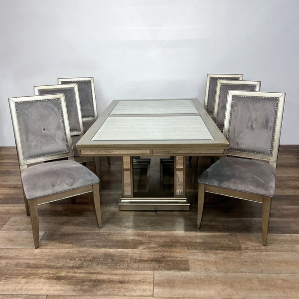 Alt text 1: Ava expandable dining table with antiqued mirrors and champagne trim, plus six grey velvet tufted chairs from Z-Gallerie.