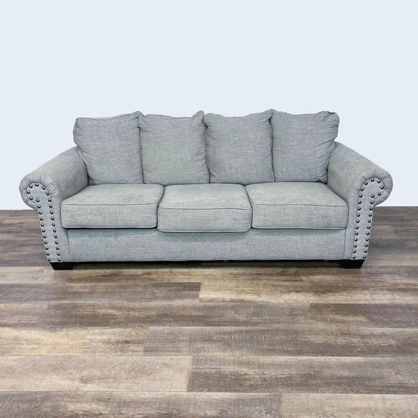 Gray Ashley Furniture sleeper sofa with roll arms and nailhead detailing, closed position.
