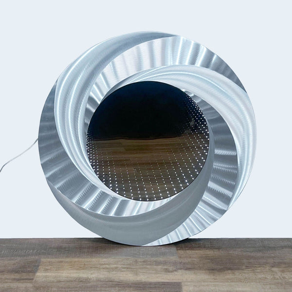 Alt text 1: Nova Lighting Infinity Vortex Mirror with a brushed aluminum finish creating an illusion of a deep light tunnel with dots of light.