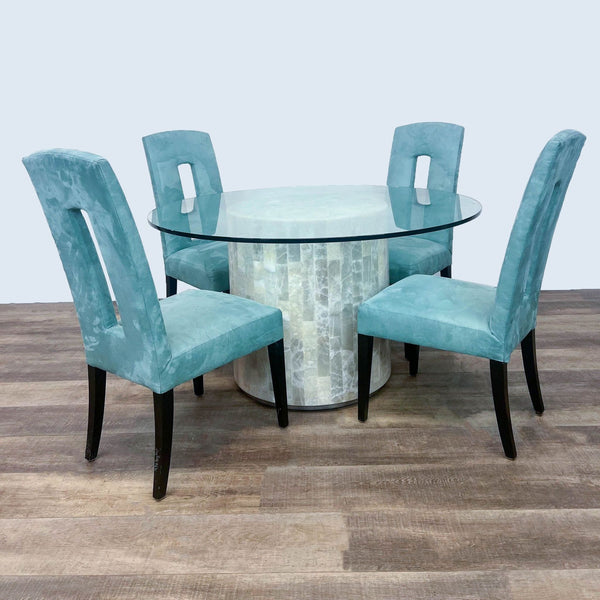 Alt text 1: Artistica 5-Piece Dining Set with a round tempered glass table on travertine stone base and four blue upholstered chairs.