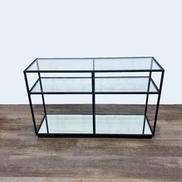 Reperch brand console table with metal frame and two glass shelves on wooden floor, front view.