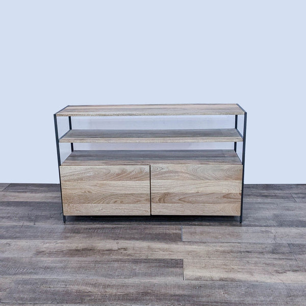 West Elm entertainment center, featuring blackened steel frame and mango wood shelves, with closed drawers.