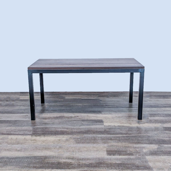Room & Board Parsons dining table with a walnut-stained wood top and a 2-inch steel hand-welded base, displayed on a hardwood floor.