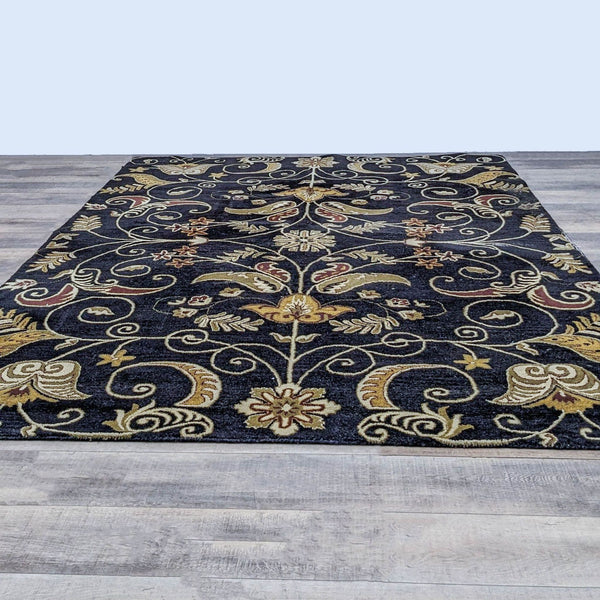 Alt text 1: The Ansley wool area rug from Home Decorators features an intricate floral pattern in gold and ivory on a dark background, displayed on a wooden floor.