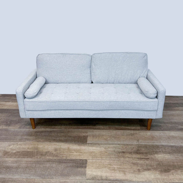 Reperch brand loveseat with tufted bench seat, wooden feet, and two bolster cushions, against a grey backdrop.