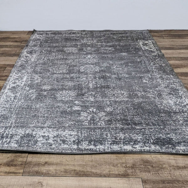 Sofia area rug by Unique Loom with a distressed gray pattern, medium pile, and laid on wooden flooring.