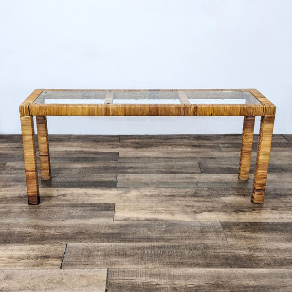 Reperch branded console table with glass top and textured wooden legs on a wooden floor.
