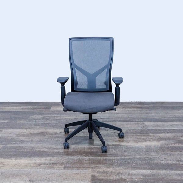 Alt text 1: Front view of a SitOnIt Torsa high back office chair with mesh backrest, adjustable armrests, and a five-star nylon caster base on a wooden floor.