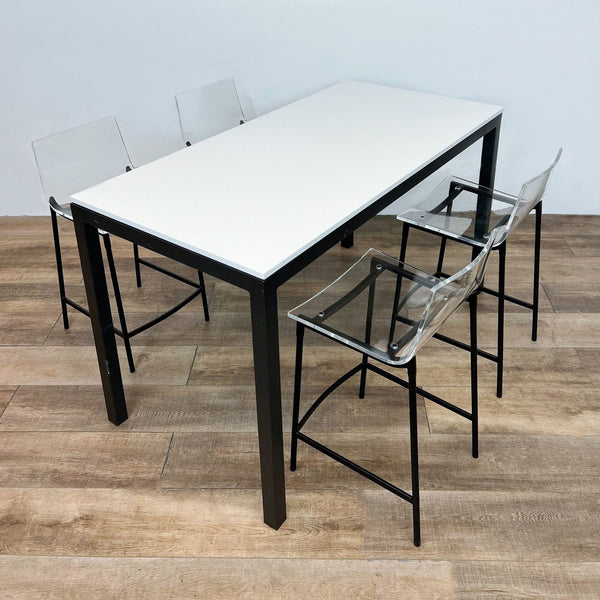 Room & Board Parsons counter height table with white quartz top and four CB2 Chiaro clear acrylic stools with black steel legs.
