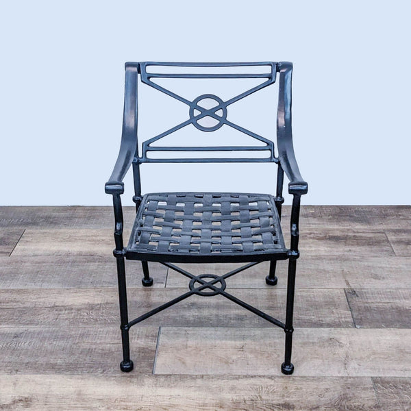 Reperch classic armchair with circular detailing and woven seat, recently powder coated, on wooden floor.