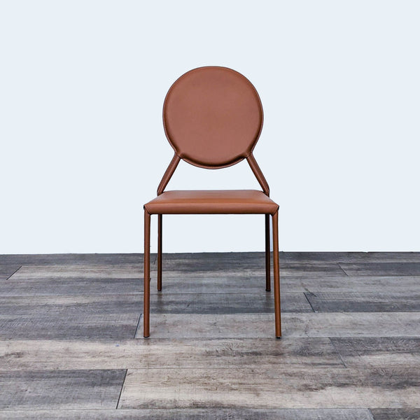 Alt text 1: Euro Style Isabella stackable side chair in cognac leather, showcasing its circular back and solid steel frame on a wooden floor.
