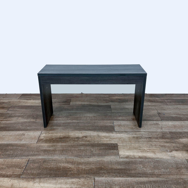 Reperch brand side table in a frontal view on wooden floor, showcasing a sleek, minimalist black design.