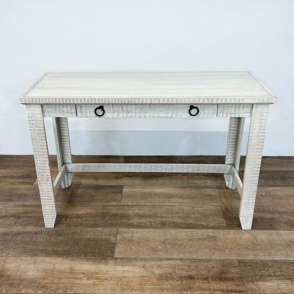 Reperch brand side table in a textured off-white finish with two black ring drawer handles on a wooden floor.