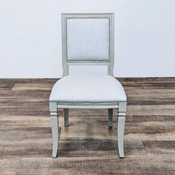 Reperch vintage French style dining chair with cushioned seat and upholstered back on wood frame, standing on a wooden floor.