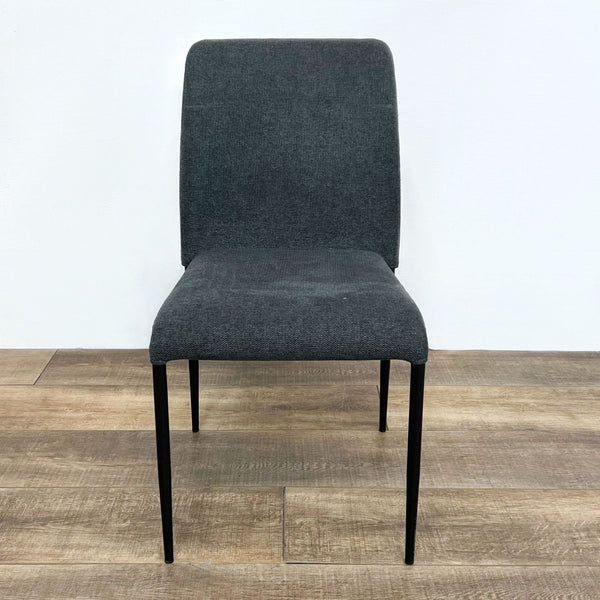 Reperch brand dining chair with dark upholstered seat and back, and black tapered legs, front view.