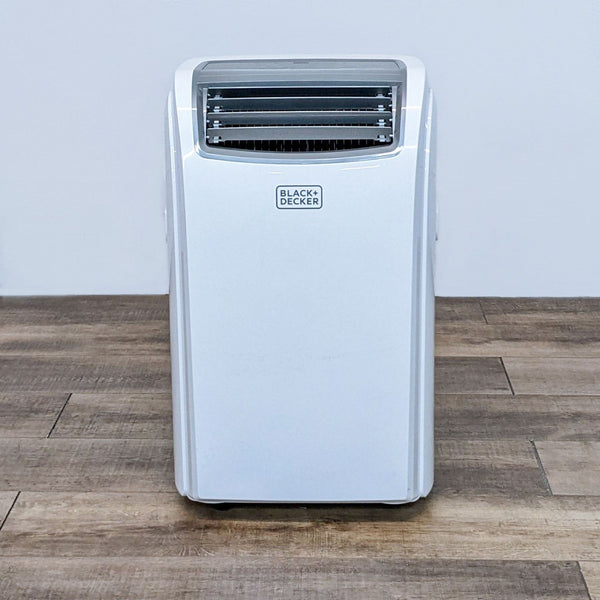 Image 1: Front view of a Black + Decker portable AC unit, with logo visible, standing on a wooden floor against a white wall.