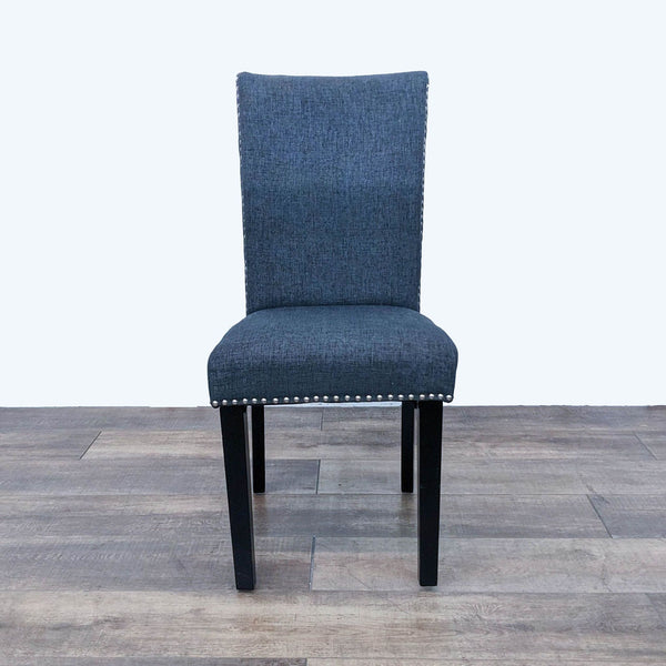 Reperch modern dining chair with blue upholstery, nailhead trim, and dark wood tapered legs, front view. 