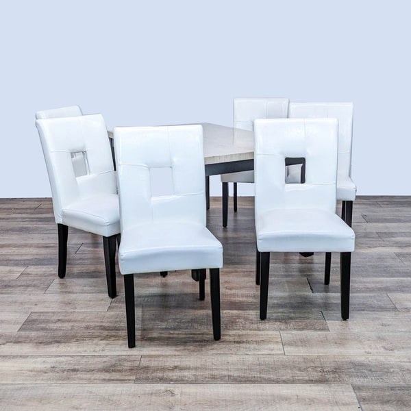 Coaster stone top dining table with square legs and six keyhole back chairs upholstered in white faux leather.