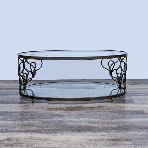 1. Oval glass-top coffee table with intricate metal base design on a wooden floor by Reperch.