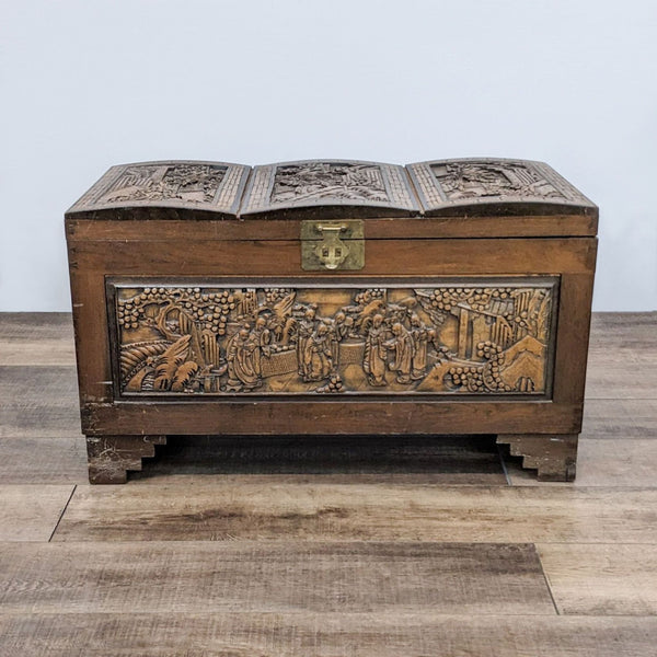 Carved Reperch trunk closed, detailed scenes on the exterior and curved top.