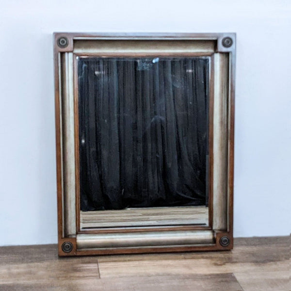 Bernhardt Furniture dark stained wall mirror with antique silver accents and distinctive bullseye corner details.