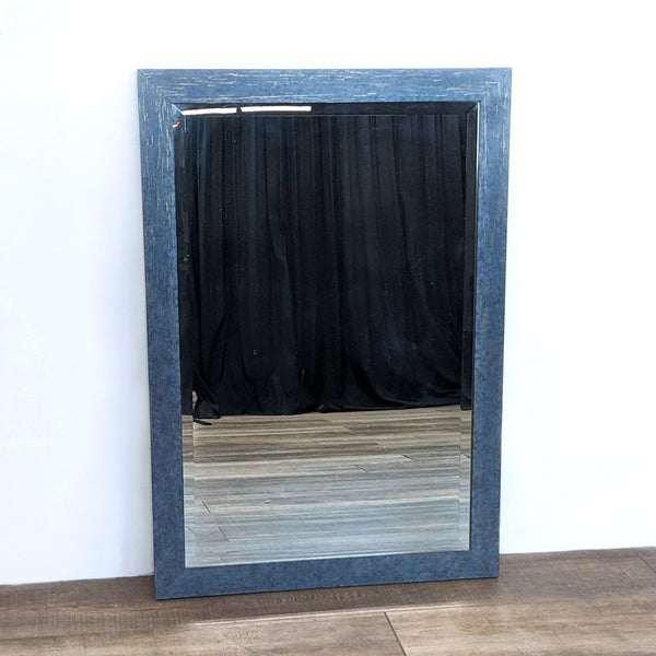 Reperch rectangle beveled wall mirror with weathered frame against interior wall.