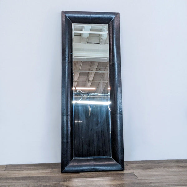 Reperch full-length mirror with dark leather frame reflecting an interior space.